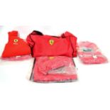 A Ferrari F1 Team Kit Bag, comprising a soft holdall numbered 014, a Puma soft bag, two pairs of