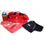 A Ferrari F1 Team Kit Bag, comprising soft holdall numbered 048, a boxed miniature racing helmet,