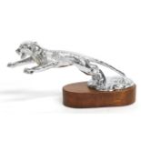 A Chrome Car Mascot in the form of a Jaguar, outstretched, on a circular base and mounted on an oval