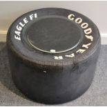 A Coffee Table in the Form of a Goodyear Eagle F1 26 X 15 X 13 Tyre, with glass top and circular