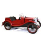 A Red Painted Pedal Car, modelled after a 1930s MG sports car, with chromed head lamps, wire