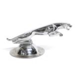 A Chrome on Brass Car Mascot in the form of a Jaguar, mounted on a circular cap, 9.5cm high Buyer'