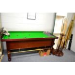 A Thurston mahogany bar billiards table, together with associated score board, lights, cues, cue