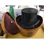 Black silk top hat in leather case (a.f.)Hat box split and very worn. Hat some rubbing and worn to