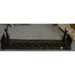 A decorative black painted fire curb of Gothic design; and a cast fire insert/grate, stamped wide