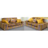 A pair of good quality sofas, upholstered in purple and mustard striped velvet, comprising a three-