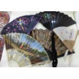 A 19th century painted fan with ivory sticks, together with four other later fans