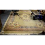 Chinese Savonneries design carpet, the pale carved field with central floral medallion enclosed by