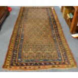 North West Persian rug, the camel field of stylised plants enclosed by triple borders, 250cm by