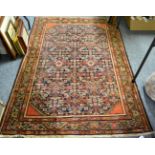 Feraghan rug, West Iran, circa 1900, the indigo Herati field framed by madder spandrels and