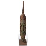 A Papua New Guinea Flute Stopper, circa 1955, carved in soft wood as a stylised crocodile, the