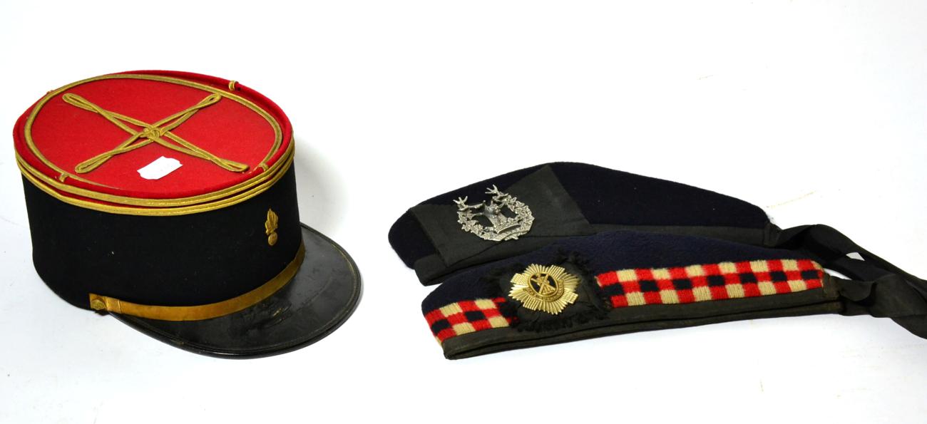 Two Glengarry Bonnets, to the Royal Scots and the Gordon Highlanders, each in blue wool with scarlet