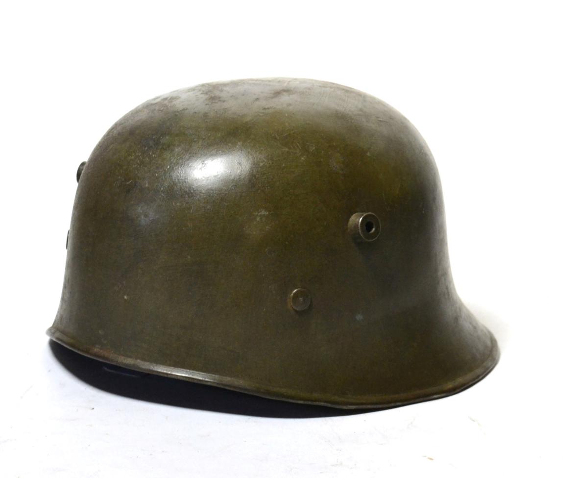 A Rare First World War Turkish Helmet, cut down from a German M17 helmet, with uneven rolled edge,