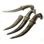 Three Indian Small Daggers, each with faux damascined curved steel blade, the hilt modelled as an