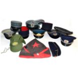 A Collection of Thirteen Various Military Caps, including Russian Army dress visor hat, Russian