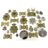 A Quantity of Militaria, including six copy helmet plates, eight dress belt buckles, a plaid brooch,