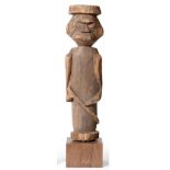 A North American Indian Carved Wood Figure, of pillar form, carved from a single piece of soft wood,