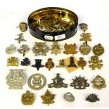 A Collection of Approximately Fifty British Military Badges, including cap, glengarry and collar