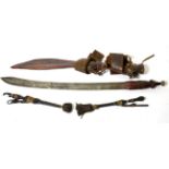 A Tuareg Sword, the 58cm single edge steel blade with two narrow fullers to the back edge and
