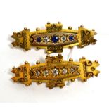 A Victorian Etruscan revival brooch, star set with five graduated old cut diamonds, to a