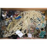 A quantity of costume jewellery, including beaded necklaces, bangles, rings, brooches