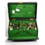 A green leather jewellery box containing various items including silver, buttons, a watch etc