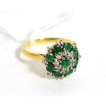 An emerald and diamond cluster ring, total estimated diamond weight 0.20 carat approximately, finger