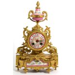 A late 19th century gilt metal pink porcelain mounted striking mantle clock