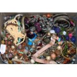 A quantity of costume jewellery, including beaded necklaces, bangles, rings, brooches