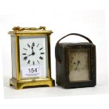 A brass carriage timepiece and another carriage timepiece in a fitted case