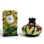 A Moorcroft pottery timepiece in the Fruit Garden pattern by Nicola Slaney, 16cm and a Moorcroft