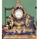 A 19th century gilt metal striking figural mantel clock with enamel dial and Roman numerals (a.f.)