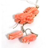 Coral pendant and pair of earrings, the brooch carved with a bird amongst flowers, measures 2.7cm