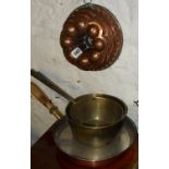 Victorian copper jelly mould, and two brass saucepans