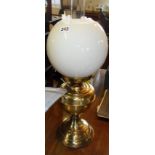Brass oil lamp with white glass spherical shade