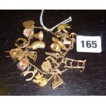 9ct gold bracelet with assorted charms including a mechanical cuckoo clock (approx 33gms)