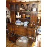 Edwardian oak dresser, the top section with cupboards & alcoves above two drawers flanked by