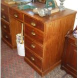 Edwardian pine kneehole pedestal desk of seven drawers with brass cup handles