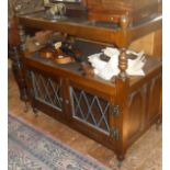 Oak two-tier tea trolley having leaded glass doors to cupboard under