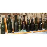 Shelf of old glass bottles with embossed brewery names (mainly West Country) associated book