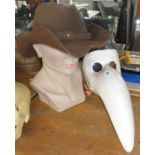 Comedia dell Arte beak mask, a leather stetson, and a man's head shop display mannequin