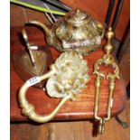 Ornate brass lion door knocker, ornate brass teapot, brass fire tongs and a shield-shaped wall