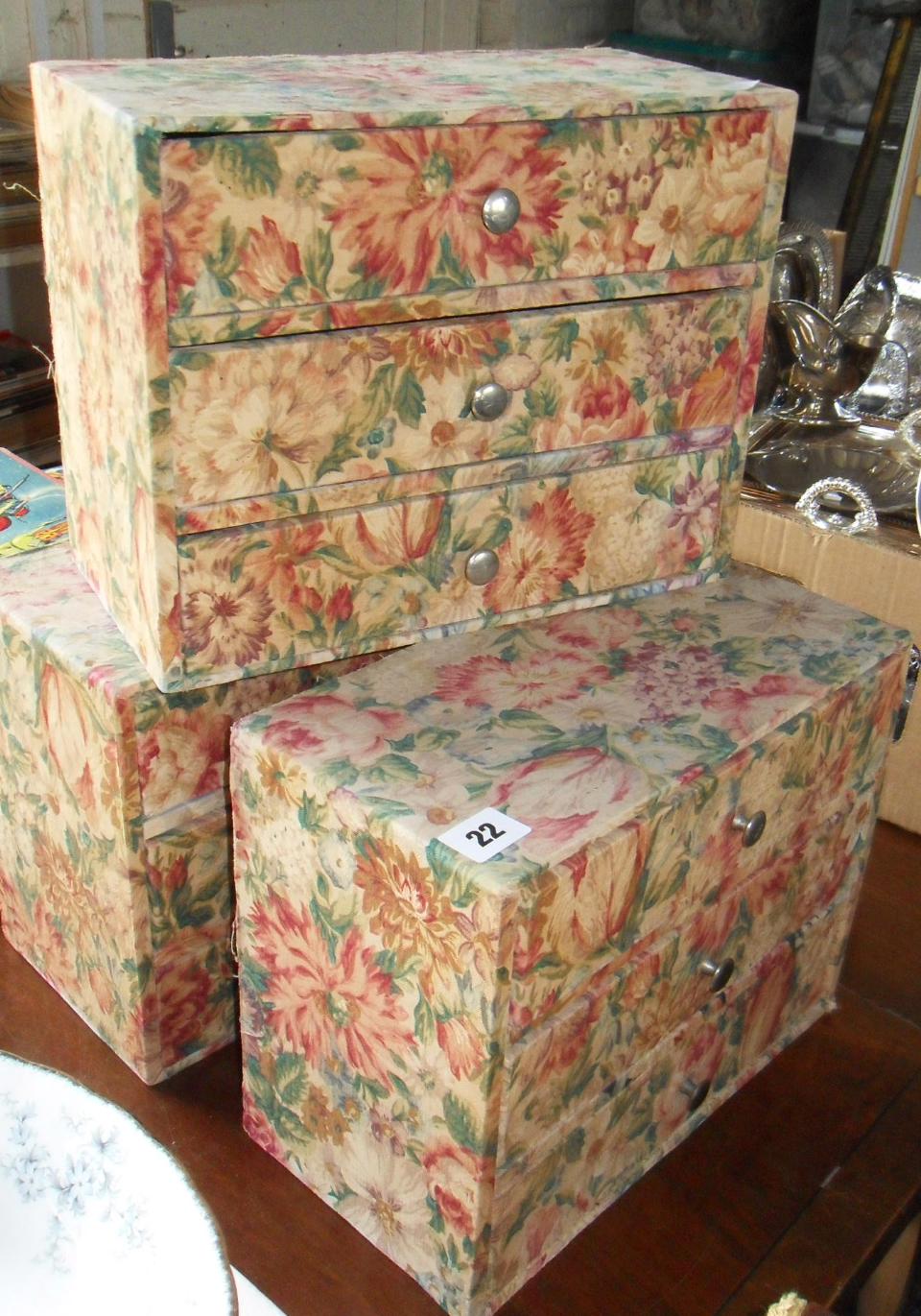 Three fabric-covered nests of three drawers