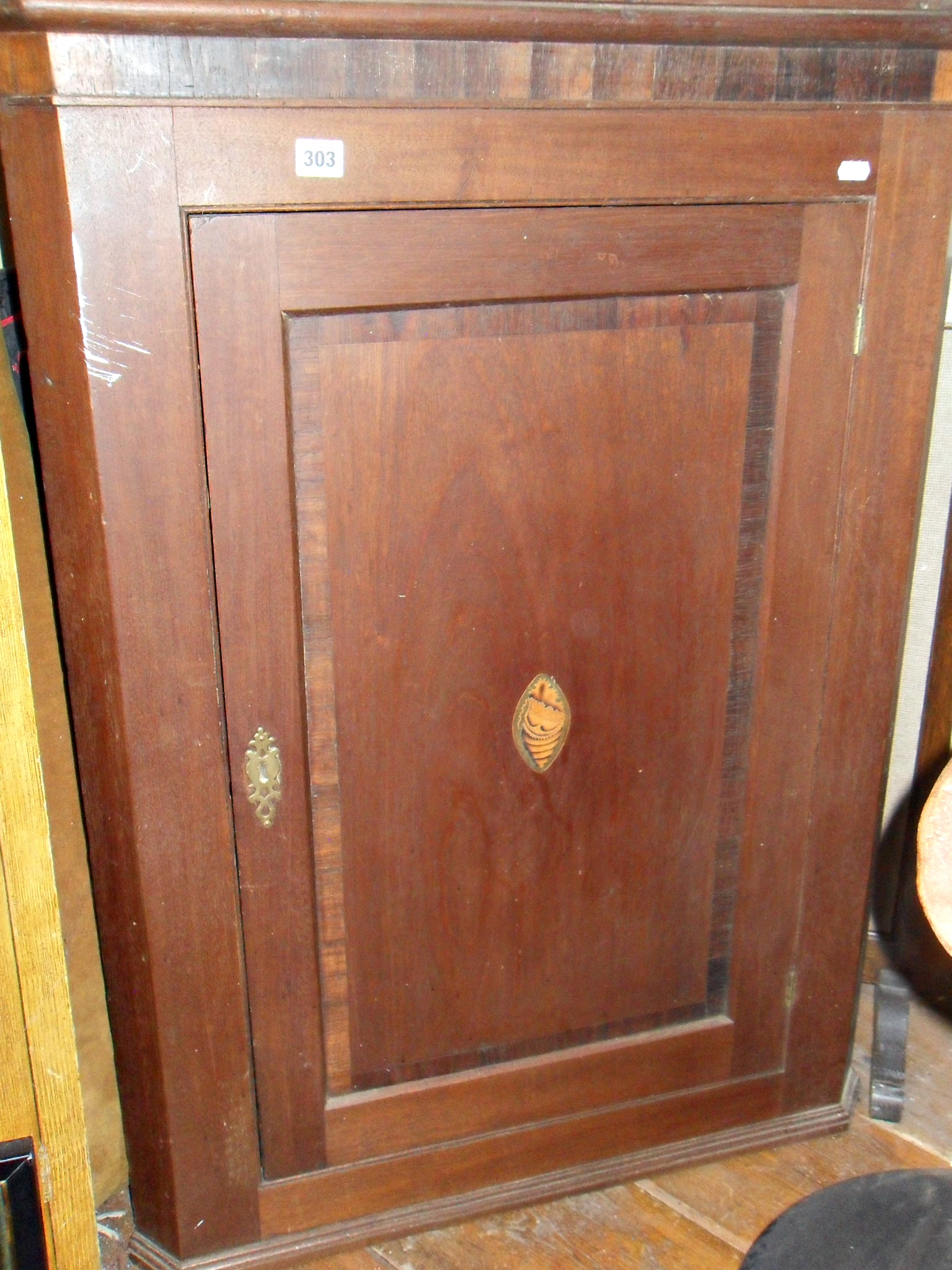 Georgian corner cupboard with cross-banded & inlaid door enclosing shaped shelves