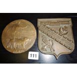 Bronze plaque "Deter through Strength", and another