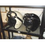 Two vintage motorbike helmets with goggles