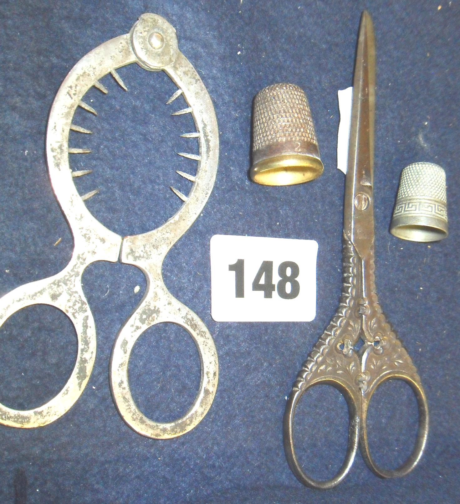 Pair of Victorian ornate steel sewing scissors, “egg” scissors, and two thimbles
