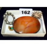 Large silver-mounted agate brooch, a star-shaped brooch set with pearls, a round 'garland' brooch