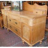 Victorian stripped pine serpentine-fronted dresser base with three drawers above two drawers flanked