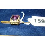 14ct (.585) gold brooch set with large lozenge cut amethyst flanked by eight small diamonds (15gms